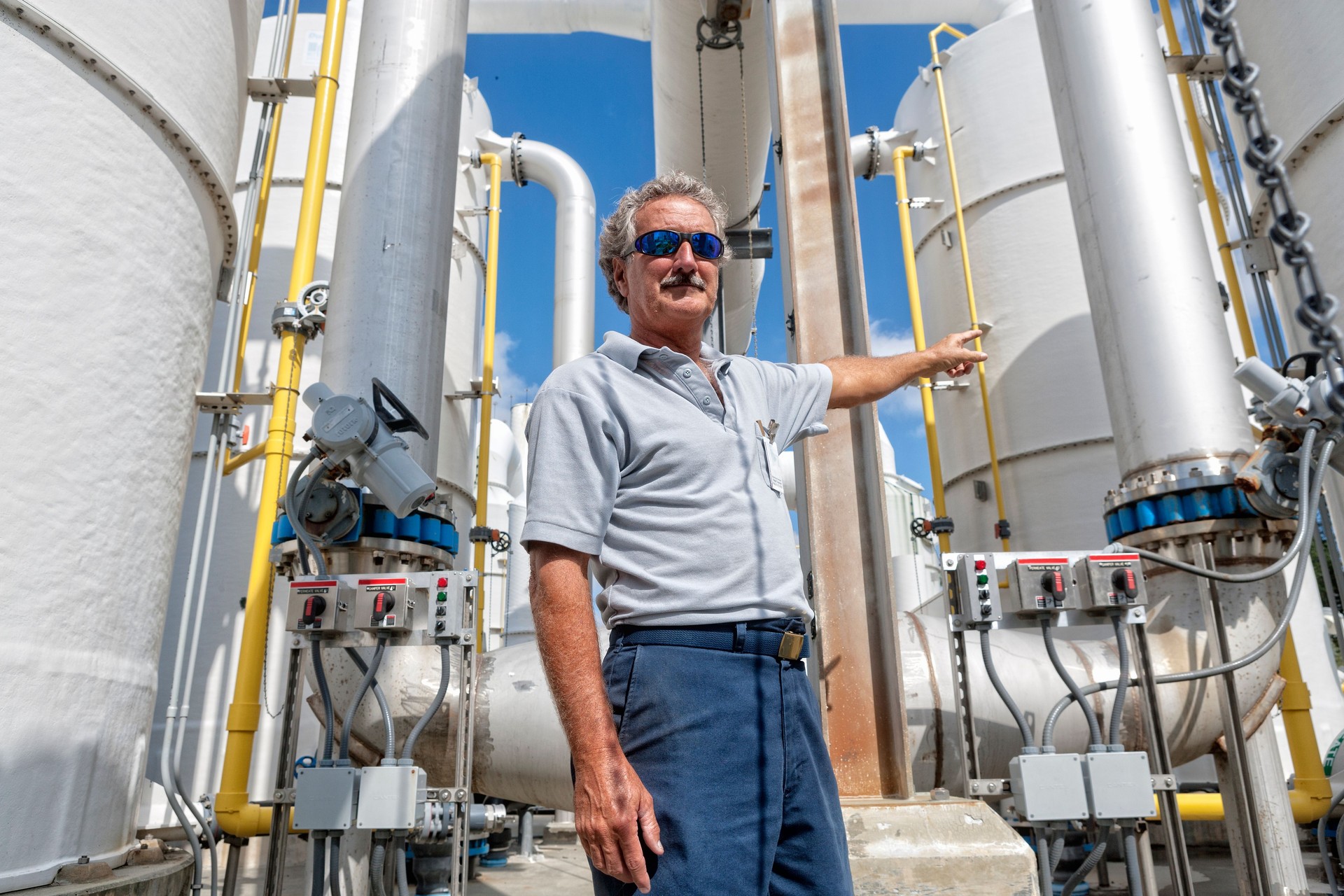 Field Technician Pointing to Chemical Tank